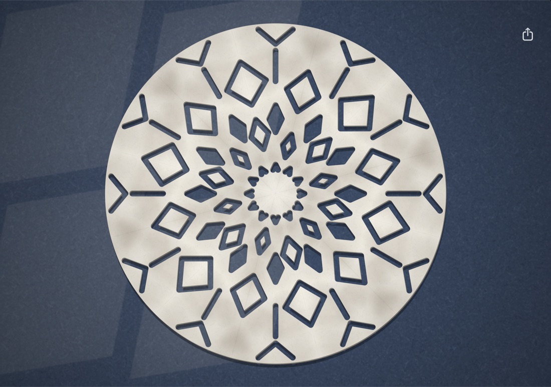 A snowflake cut from a wedge of twelve layers, unfolded on the Duo.